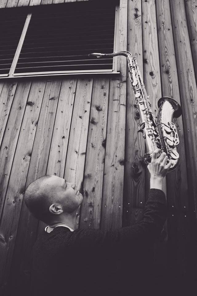 Taavi Toomsalu holding a tenor saxophone